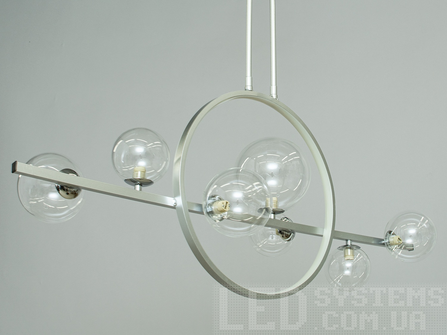 Лаконічний і в той же час дуже елегантний дизайн цієї люстри на 7 ламп в стилі лофт підійде для цінителів мінімалізму і свободи думки в інтер'єрі. Люстри в стилі &laquo;лофт&raquo; ідеально впишуться в сучасні будинки, квартири, кафе, арт-простір, коворкінги, квеструми. Матові акрилові плафони ідеально розсіяють світло від лампи будь-якого типу. Родзинкою люстри є світлодіодне кільце. Його можна підключити разом з лампами, або включати окремо, як мінімальне світло люстри. Потужність близько 10Вт і теплий колір світіння створюють затишне освітлення за столом. Порівнянне зі світлом свічок. Для яскравого 