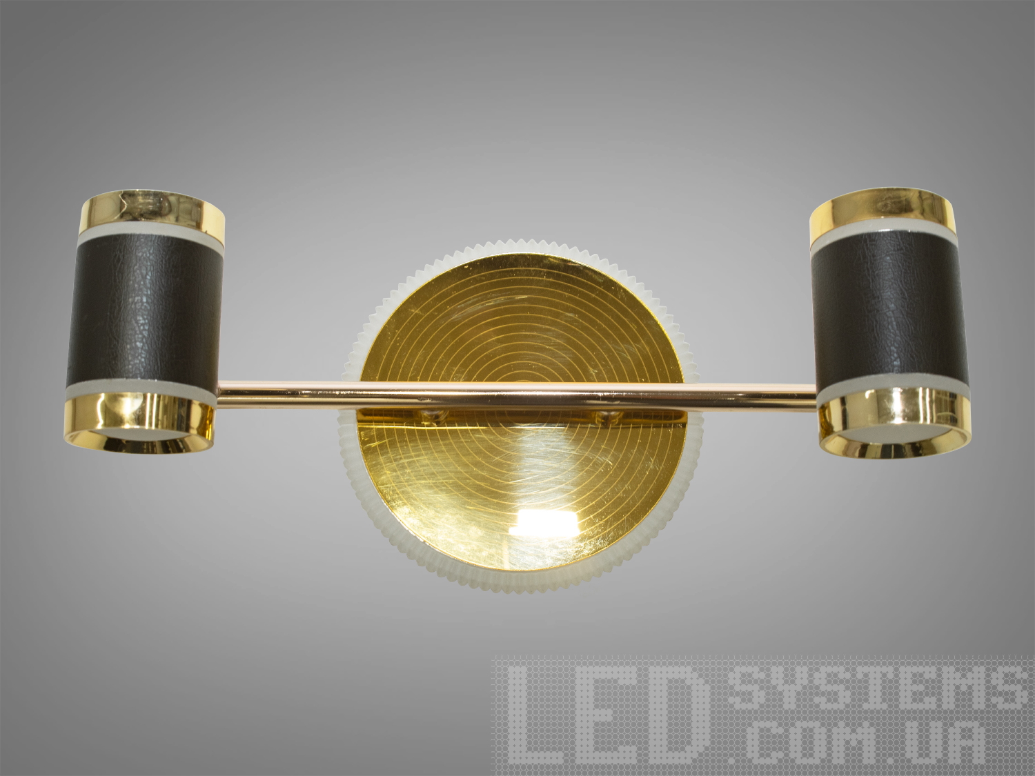 Настінний LED світильник 15W у золоті з чорними акцентами. Два циліндричні плафони, регулювання 3200–4100–6000K від настінного вимикача. Для дзеркал і картин.