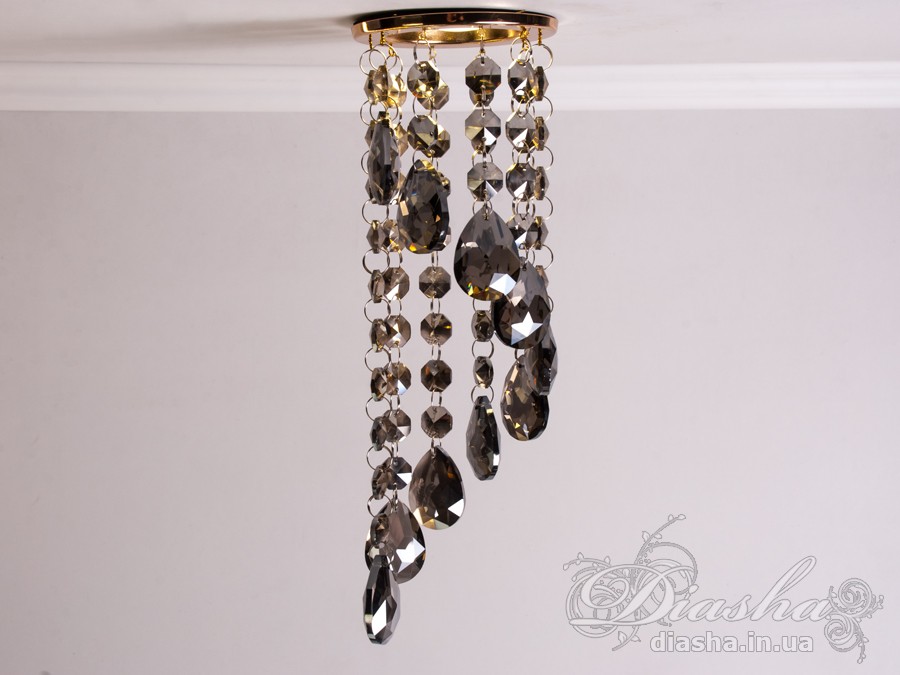 Цей розкішний врізний точковий світильник з кришталевими підвісами від ТМ &laquo;Діаша&raquo; віддзеркалює розкіш і вишуканість, пропонуючи більше ніж просте освітлення &ndash; він вносить елементи мистецтва та елегантності в інтер'єр. Ця унікальна освітлювальна прикраса втілює бездоганний баланс між функціональністю та дизайном, привносячи в будь-яку кімнату ауру ексклюзивності та стилю.
Кожен кришталь, відшліфований до досконалості, створює гіпнотичний ефект, м'яко відбиваючи світло та розкидаючи його по кімнаті у вигляді динамічного візерунка іскринок. Кришталі підвішені на тонких, ледве помітних нитках, ніби парять у повітрі, зачаровуючи своєю грацією та легкістю. Вони перетворюють кожен випадковий промінь світла в святковий феєрверк, наповнюючи простір теплим світінням та витонченою атмосферою.
Цей світильник ідеально підходить для вітальні, де він може стати яскравим акцентом та центром уваги, допомагаючи створити атмосферу розкоші та комфорту для прийому гостей. У кухні він додасть сяйва та благородства, підсилюючи апетитність страв та красу приготування. У спальні, врізний точковий світильник з кришталевими підвісами забезпечить м'яке та заспокійливе освітлення, створюючи ідеальне середовище для відпочинку та релаксації.
У громадських просторах, таких як кафе, світильник створить особливу, неповторну атмосферу, де кожен промінь світла виграє в кришталях, додаючи інтер'єру вишуканості та шарму. Придбати цей світильник можна недорого, що робить його доступним вибором для тих, хто бажає додати елементи розкоші в свій простір без зайвих витрат.
Стилістика світильника притаманна багатьом дизайнерським напрямкам: від класичного і ретро до сучасного мінімалізму та індустріального шику. Він уособлює в собі естетику, яка перевершує тренди, залишаючись актуальною та елегантною в будь-якій епосі.