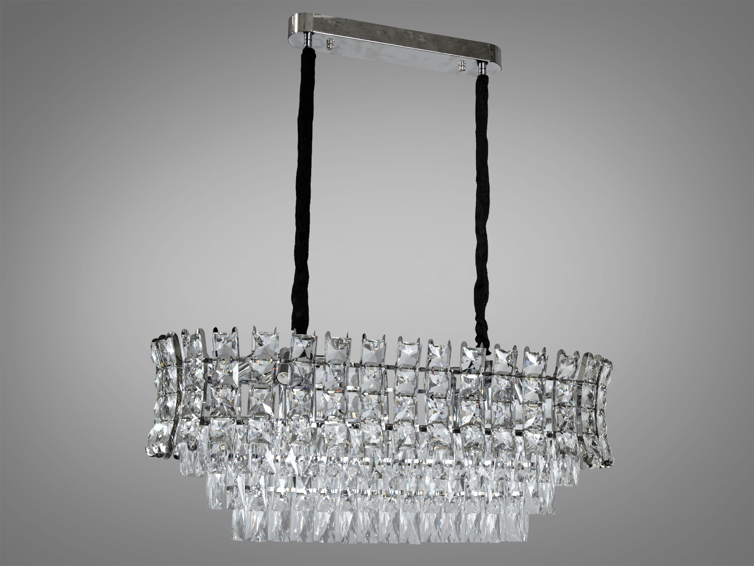 Кришталева люстра овальної форми для вітальні-їдальні ідеально підійде до класичних, сучасних або навіть мінімалістичних інтер'єрів, надаючи їм шарму та елегантності. Вона може бути використана в різних просторах: від гостьових кімнат та спалень до великих залів та конференц-залів.
Пропорції овальних люстр абсолютно гармонують із великими обідніми столами. Люстра спеціально розрахована так, що максимум яскравого світла потрапить на стіл, а решта приміщення наповниться м'яким розсіяним світлом кришталевими підвісками. На неї можна дивитися під будь-яким кутом.
Люстра складається з кількох рядів ретельно відполірованих кришталів, що відбивають світло, створюючи блискуче та живе освітлення у всьому просторі. Кожен кришталь відточений до досконалості, щоб максимізувати гру світла та тіні, надаючи інтер'єру неперевершений шарм та елегантність.
Каркас люстри виконаний у хромованому стилі, що надає сучасному відчуттю розкоші та стильно контрастує із прозорістю кришталів. Чіткі лінії та овальна форма каркасу підкреслюють геометричну гармонію, що є ключовим елементом сучасного дизайну.
Підвісна система люстри забезпечена тросами, оповитими в чорну тканину, які надають їй відчуття легкості та плавності. Це рішення дозволяє люстрі здаватися як би ширяє в повітрі, справляючи враження невагомості і витонченості.
Висота люстри регулюється, завдяки чому підходить для низьких стель. Люстра-підвіс під звичайні лампочки розжарювання, економки або світлодіодні лампи із цоколем Е14. Стельове кріплення підходить для підвісних, натяжних та звичайних стель.
Увага. Вага люстри Вага: 13.9 кг.
Лампи до комплекту не входять.