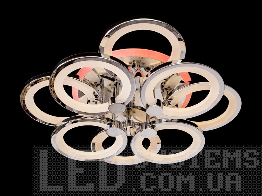 Світлодіодна люстра у вітальню з пультом, з підсвічуванням, з димером підходить на площу приміщення приблизно 21кв.м. Застосовується для зали, вітальні, кухні, спальні, їдальні, дитячої, тому що відсутні елементи, що б'ються.
Світлодіодна люстра має кілька режимів: холодний 6000К, нейтральний 4100К, теплий 3200К, кольорове підсвічування, суміщений режим &ndash; будь-яке основне світло плюс будь-який колір світлодіодного підсвічування. Регулювання яскравості люстри від 5 до 100% відбувається за допомогою пульта дистанційного керування, що входить до комплекту.
Люстра світить яскраво, але не сліпить за рахунок матеріалу &ndash; акрилу, до того ж цей матеріал дуже міцний &ndash; його важко зашкодити. Кріпиться до стелі будь-якого типу універсальним кріпленням на монтажну планку.