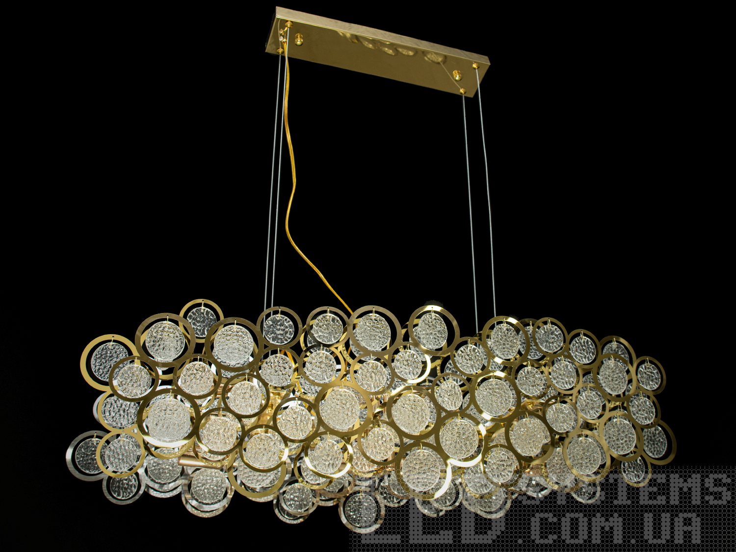 Люстра підвіс у їдальню зі скляними елементами в металевому корпусі добре виглядатиме в сучасному інтер'єрі зали, вітальні, спальні, коридору або кухні. На неї можна дивитися під будь-яким кутом, і не дивлячись на легкість конструкції люстри, ви завжди бачитимете лампи тільки через скляні підвіски. Висота люстри регулюється, завдяки чому підходить для низьких стель.
Сучасна люстра під звичайну лампочку із цоколем Е14. Стельове кріплення на планку універсальне підходить для підвісних, натяжних та звичайних стель.
Увага. Вага люстри понад 10кг.