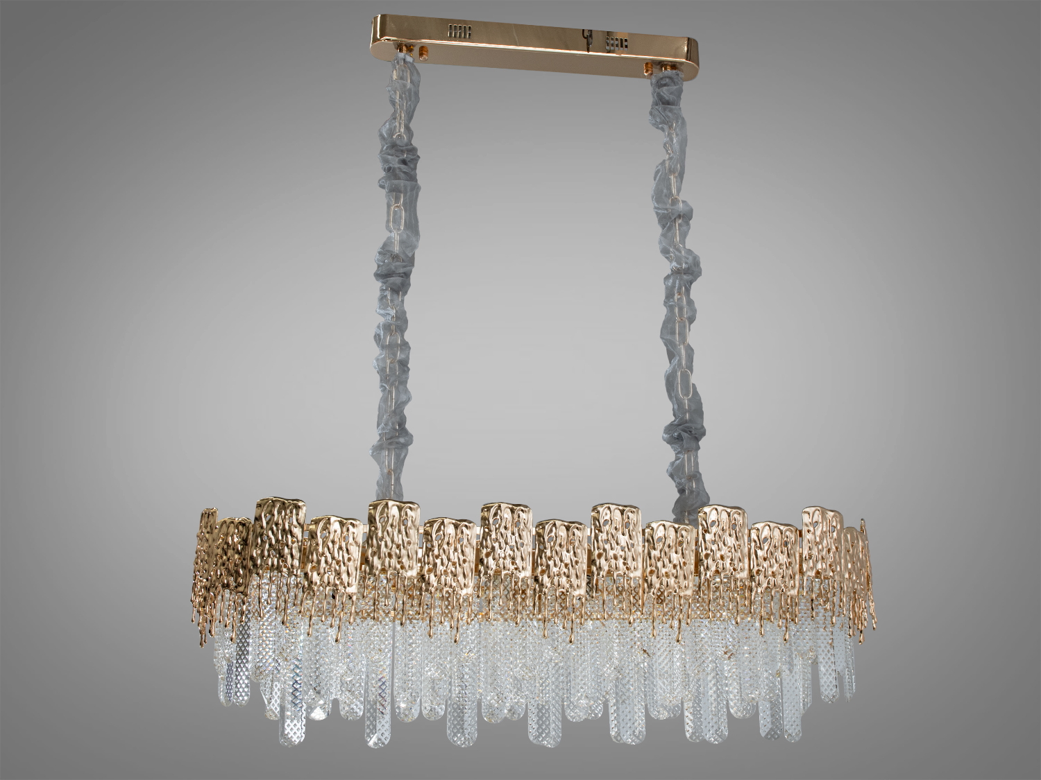 Дизайнерська кришталева люстра овальної форми для залу ідеально підійде до класичних, сучасних або навіть мінімалістичних інтер'єрів, надаючи їм шарму та елегантності. Вона може бути використана в різних просторах: від гостьових кімнат та спалень до великих залів та конференц-залів.
Пропорції овальних люстр абсолютно гармонують із великими обідніми столами. Люстра спеціально розрахована так, що максимум яскравого світла потрапить на стіл, а решта приміщення наповниться м'яким розсіяним світлом кришталевими підвісками. На неї можна дивитися під будь-яким кутом.
Конструкція люстри починається з елегантної підвіски, що граційно спускається вниз від стелі. Це плавне з'єднання між стелею та основним тілом люстри не тільки підтримує структуру, але додає декоративний елемент, який привертає увагу, підкреслюючи висоту простору.
Основна частина люстри, яка найбільше привертає увагу - це блиск плавленого металу, виконаний у золотистих тонах, який обрамляє кришталеві елементи зверху, немов плавлений метал стікає кришталем, створюючи ніжний контраст між теплими і холодними відтінками. Ця металева частина служить не тільки структурною основою, а й відіграє роль відбивача променів, що внутрішньо висвітлює кришталі зсередини, створюючи тепле, приємне світло.
Висота люстри регулюється, завдяки чому підходить для низьких стель. Люстра-підвіс під звичайні лампочки розжарювання, економки або світлодіодні лампи із цоколем Е14. Стельове кріплення підходить для підвісних, натяжних та звичайних стель.
Увага. Вага люстри 14кг.
Лампи до комплекту не входять.