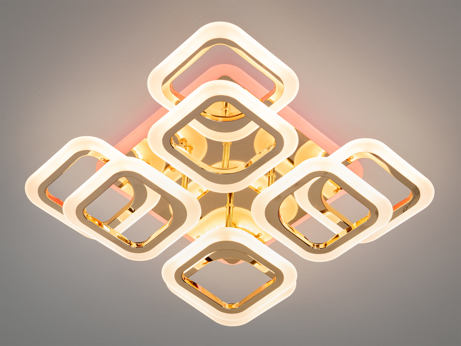 Стельова LED люстра квадратами з пультом - це геометрична симфонія світла, в якій суворі форми поєднуються з пластичністю візуального сприйняття. Її основа — це вісім світлових модулів у формі квадратів, що округляють, організованих у два рівні з легким зміщенням.