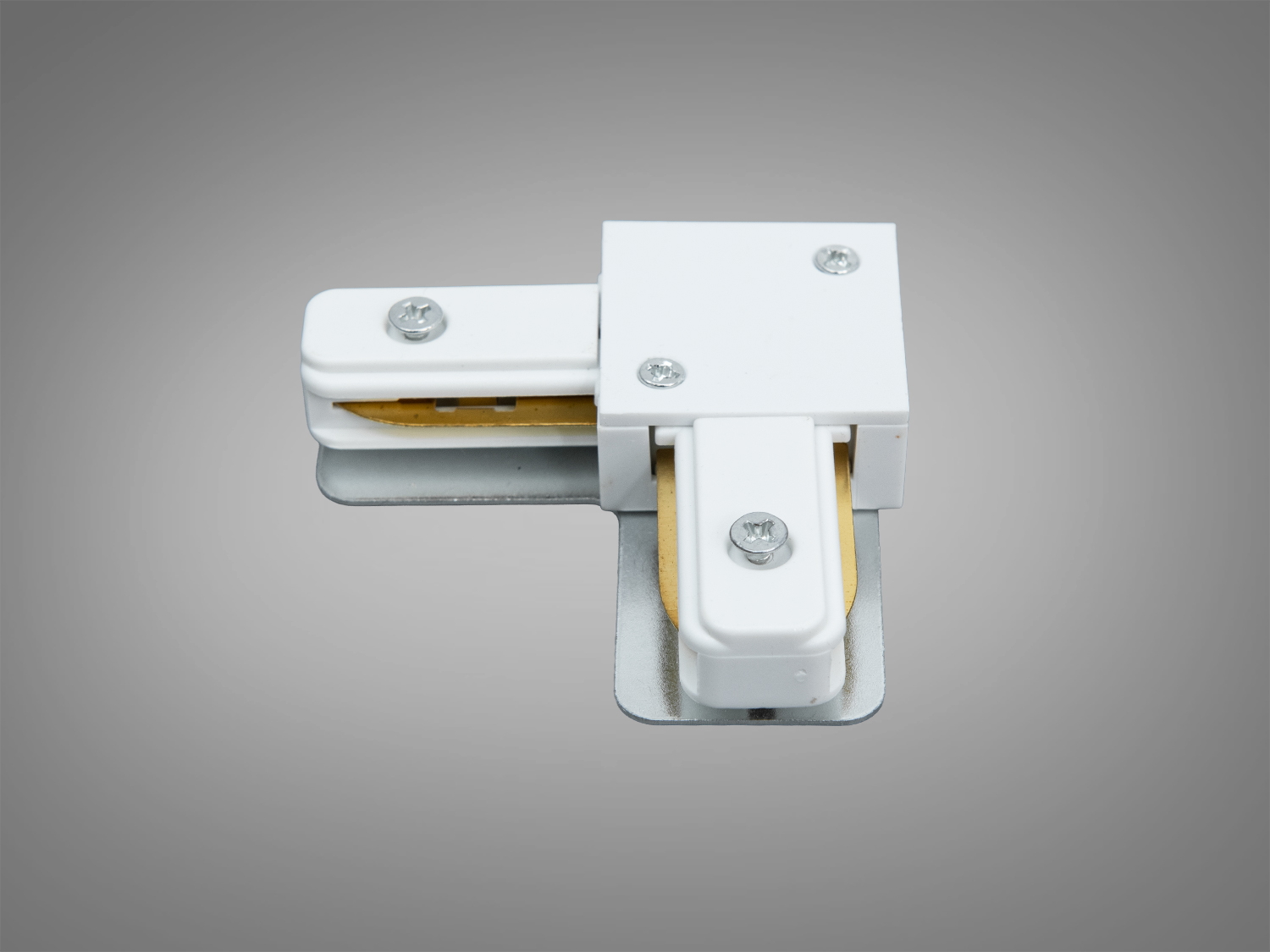 Білий кутовий L з’єднувач для трекової системи 220 В серії 1209. Формує чистий поворот на 90°, металеві контакти та гвинтове кріплення для надійного монтажу в інтер’єрі.