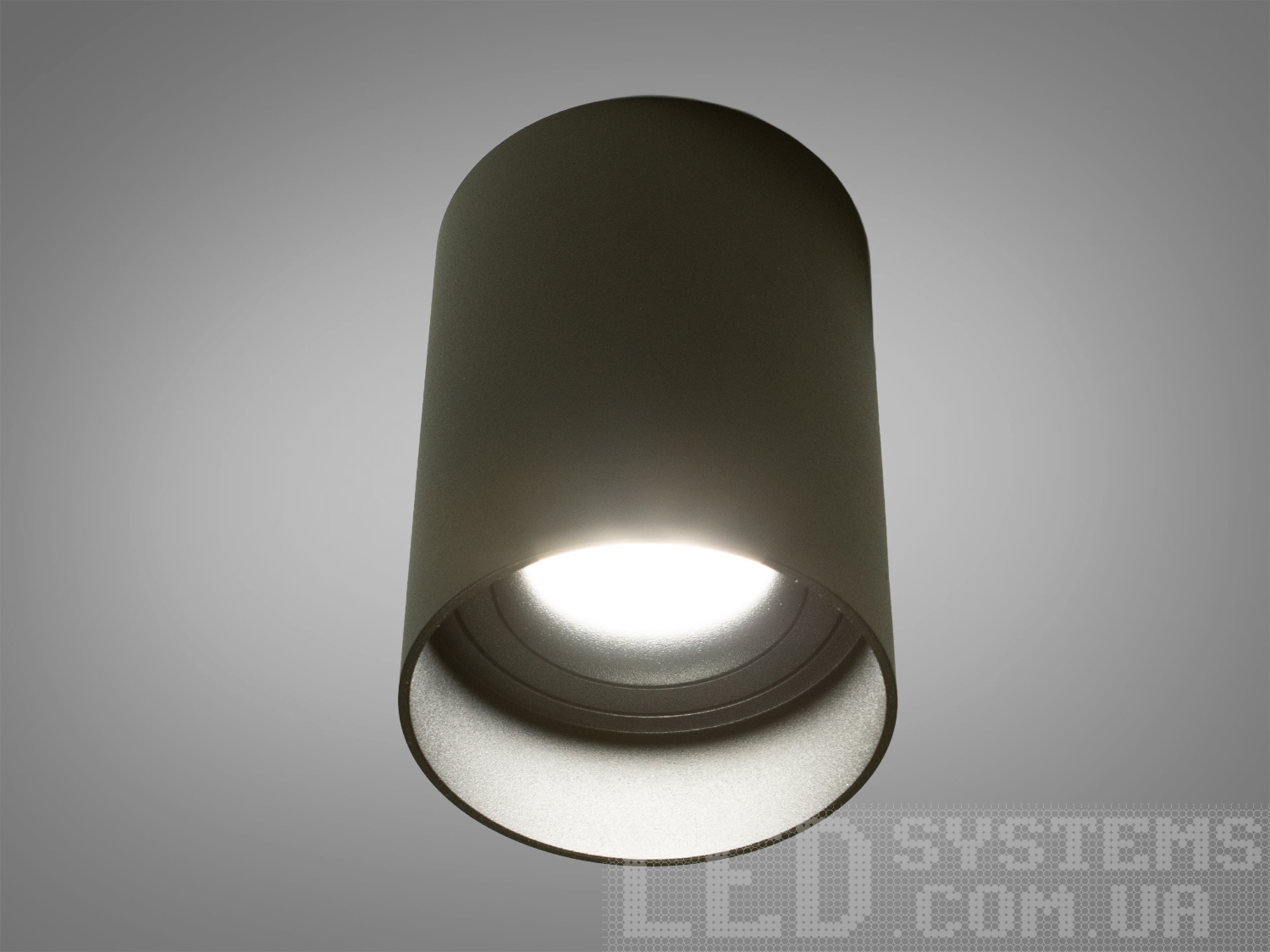 Накладний точковий світильник циліндричної форми.